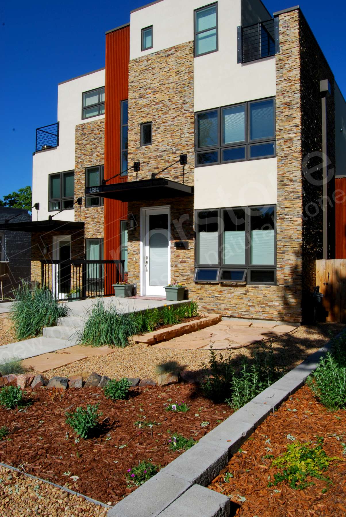 Norstone Ochre Stacked Stone Rock Panels on entryway and front facade of duplex in Colorado
